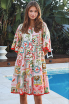 Woman wearing Zimmy tiered mini dress in rayon with button-through front and bohemian print by Salty Palm Australia