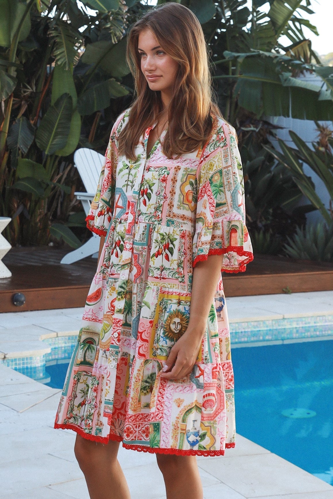 Woman wearing Zimmy tiered mini dress in rayon with button-through front and bohemian print by Salty Palm Australia