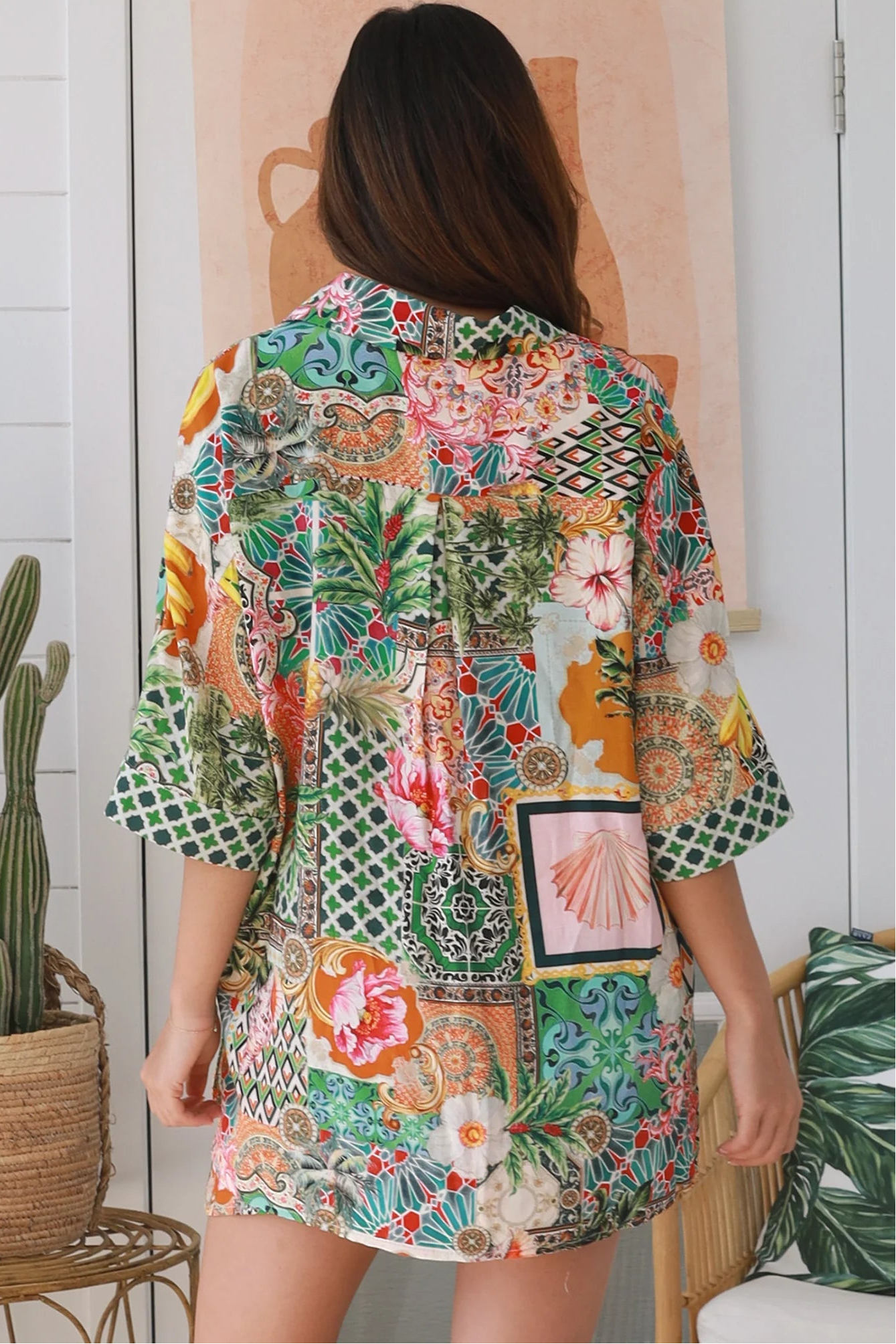 “Woman wearing tropical boho rayon shirt with border sleeves and pleated back – Amira Island Dream Shirt by Dreamcatcher, Bohemian Love Runway”