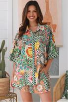 “Woman wearing tropical boho rayon shirt with border sleeves and pleated back – Amira Island Dream Shirt by Dreamcatcher, Bohemian Love Runway”
