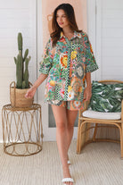 “Woman wearing tropical boho rayon shirt with border sleeves and pleated back – Amira Island Dream Shirt by Dreamcatcher, Bohemian Love Runway”