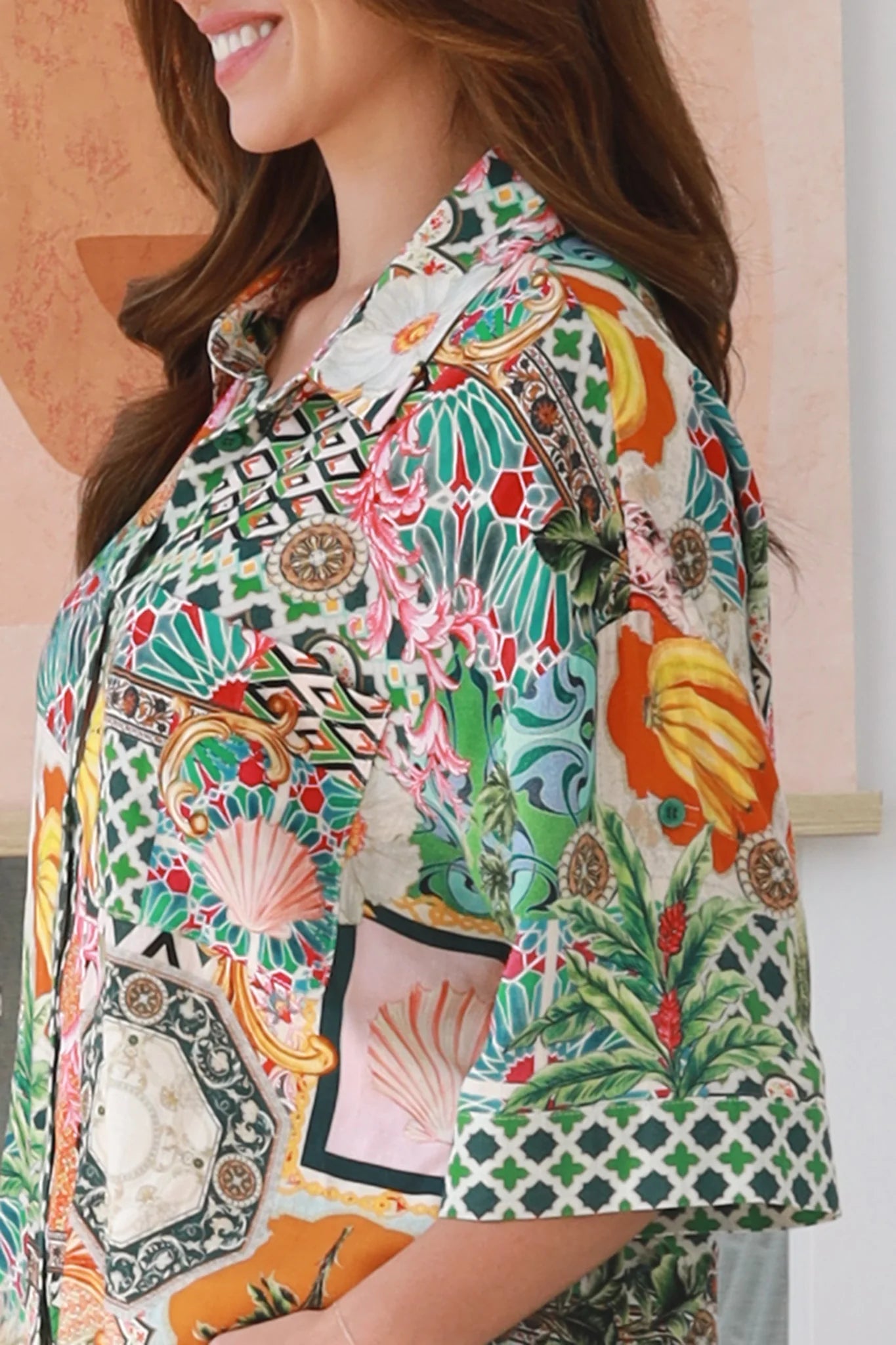 “Woman wearing tropical boho rayon shirt with border sleeves and pleated back – Amira Island Dream Shirt by Dreamcatcher, Bohemian Love Runway”