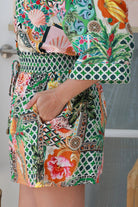 “Woman wearing tropical boho rayon shorts with border waistband and tie front – Amira Island Dream Shorts by Dreamcatcher, Bohemian Love Runway”
