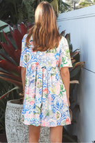 Boho mosaic mini dress with tassel ties and empire-line silhouette in colourful floral print for summer style Australia