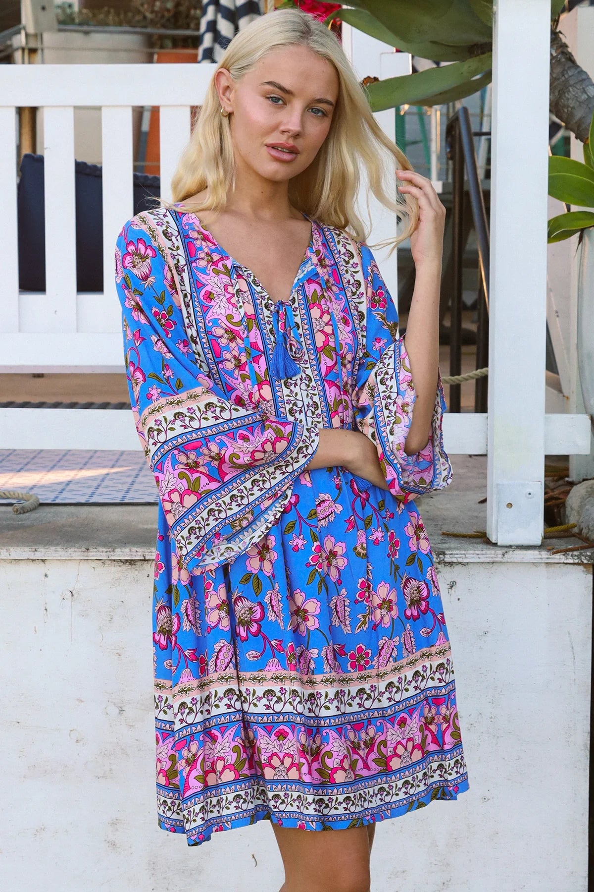Bluebell riviera mini dress in seaside blue with picturesque florals tassel neckline and bell sleeves - boho mini dress Australia