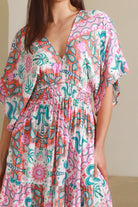 Model twirling in Fiorella Maxi Bohemian dress with pink aqua coral teal print — Dreamcatcher Dresses Australia