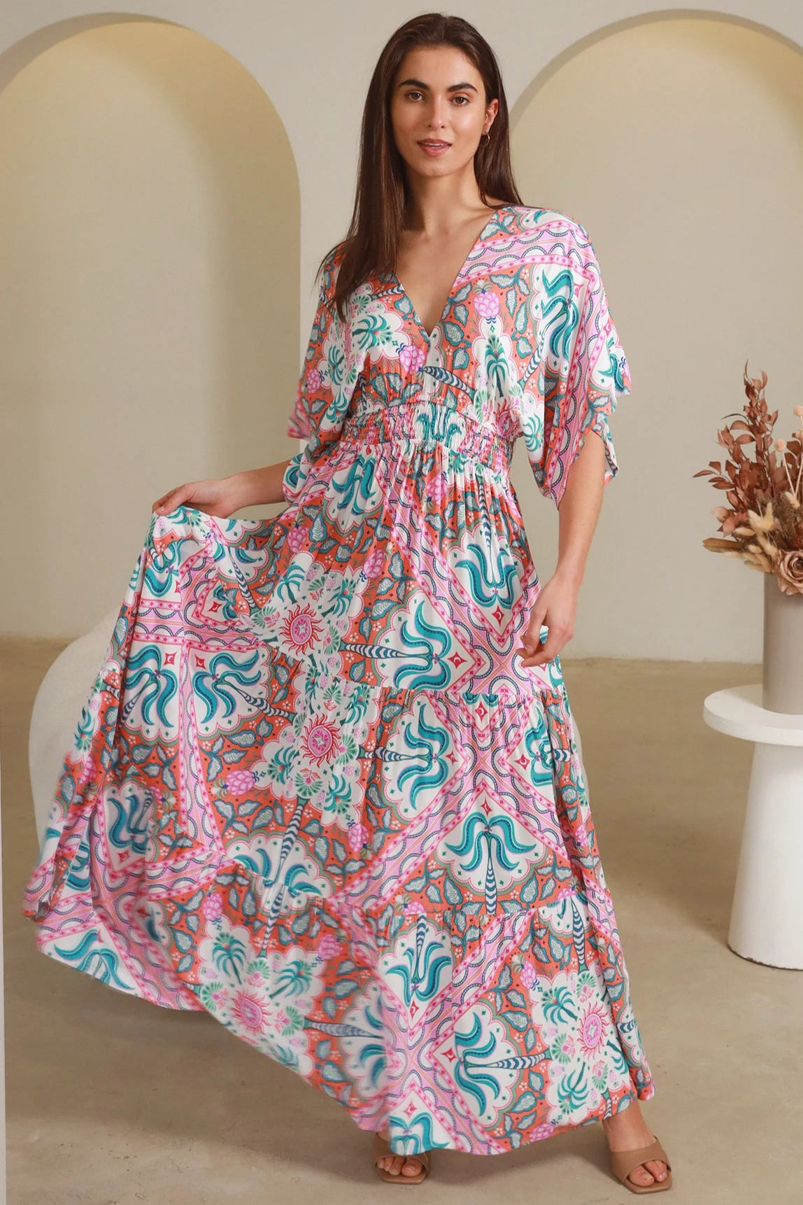 Model twirling in Fiorella Maxi Bohemian dress with pink aqua coral teal print — Dreamcatcher Dresses Australia