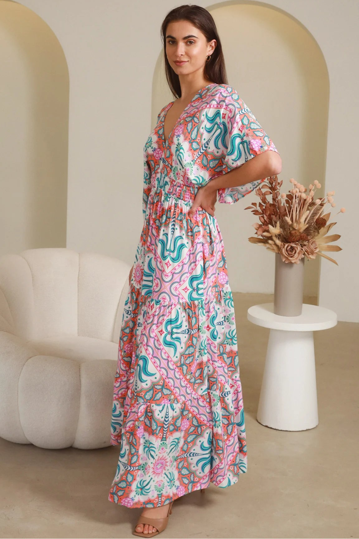 Model twirling in Fiorella Maxi Bohemian dress with pink aqua coral teal print — Dreamcatcher Dresses Australia