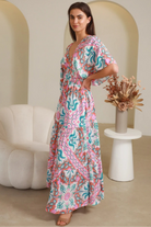 Model twirling in Fiorella Maxi Bohemian dress with pink aqua coral teal print — Dreamcatcher Dresses Australia