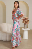 Model twirling in Fiorella Maxi Bohemian dress with pink aqua coral teal print — Dreamcatcher Dresses Australia