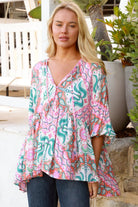 Model wearing Fiorella Boho Top in pink aqua coral teal print with voluminous sleeves - boho blouse Australia