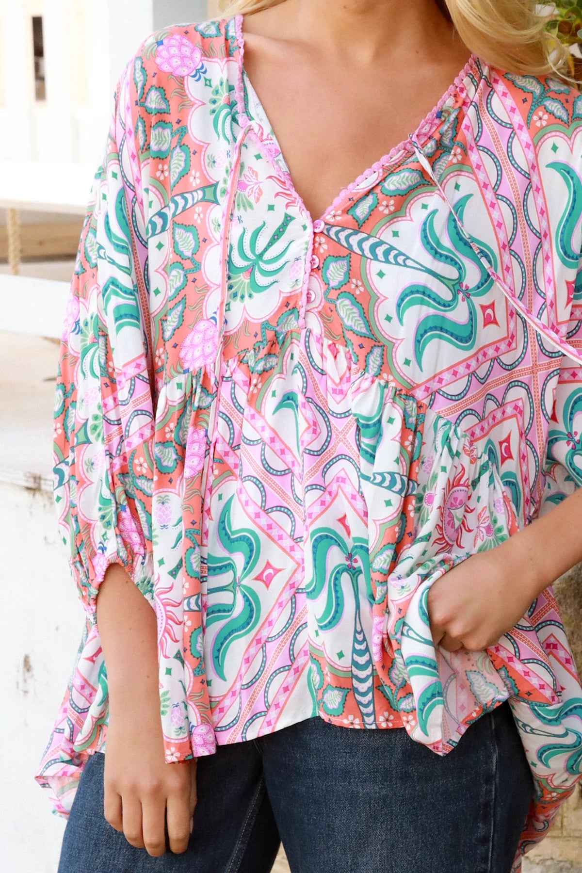 Model wearing Fiorella Boho Top in pink aqua coral teal print with voluminous sleeves - boho blouse Australia