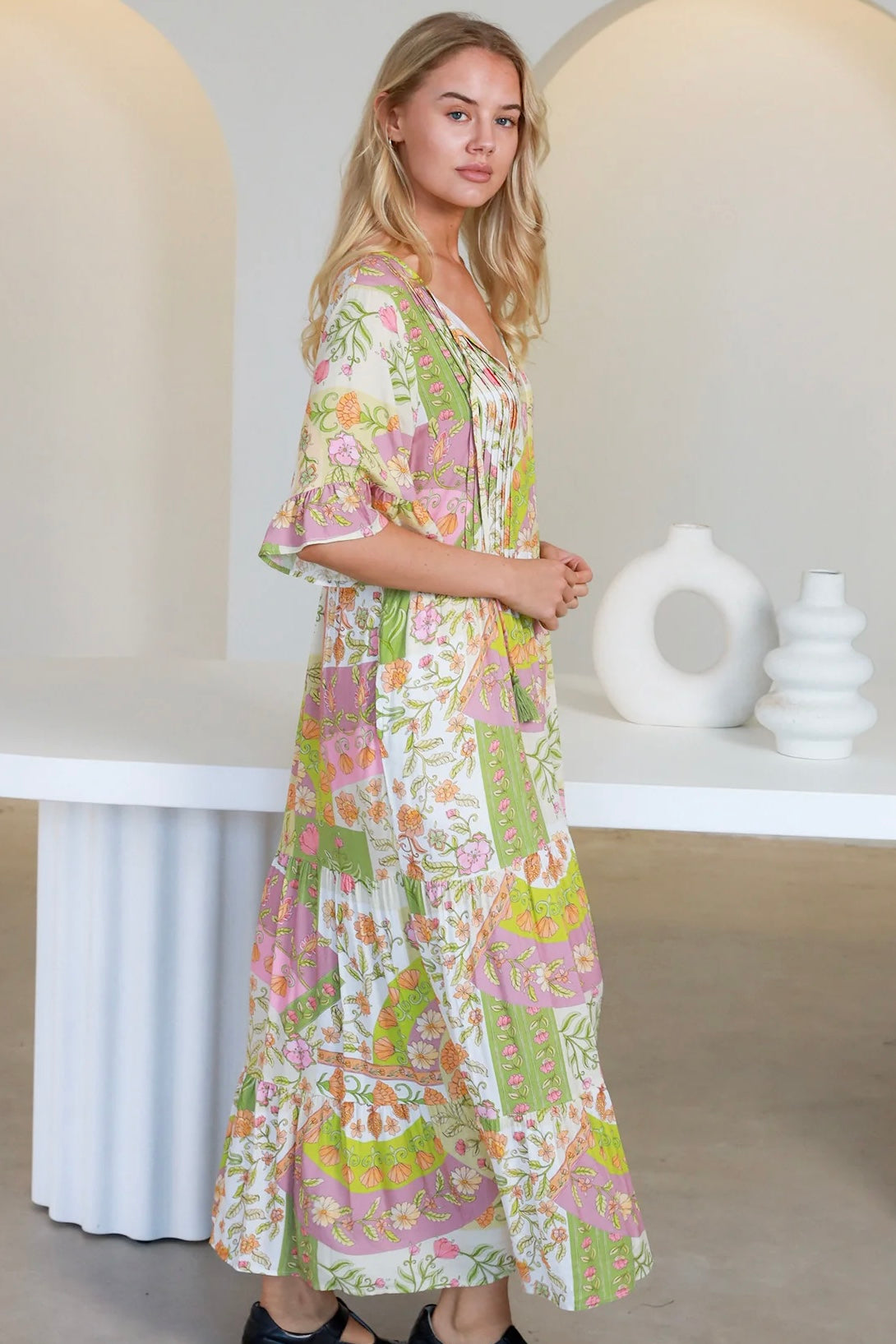 “Woman in vintage floral boho midi-maxi dress with tassel ties, frilled sleeves and tiered skirt – boho midi dresses Australia”