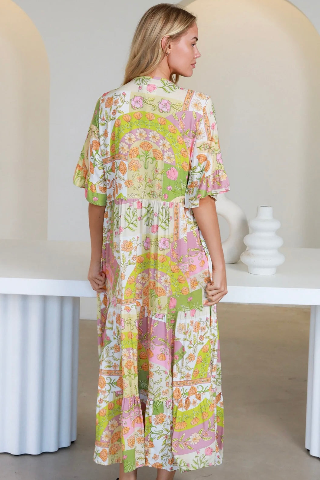 “Woman in vintage floral boho midi-maxi dress with tassel ties, frilled sleeves and tiered skirt – boho midi dresses Australia”