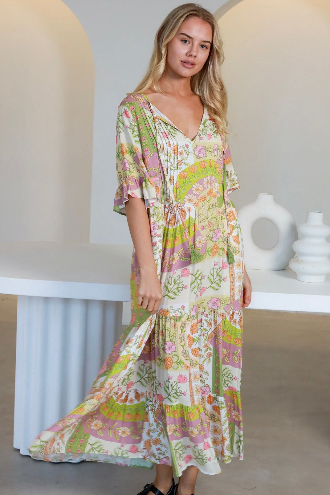 “Woman in vintage floral boho midi-maxi dress with tassel ties, frilled sleeves and tiered skirt – boho midi dresses Australia”