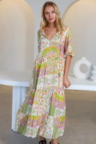 “Woman in vintage floral boho midi-maxi dress with tassel ties, frilled sleeves and tiered skirt – boho midi dresses Australia”