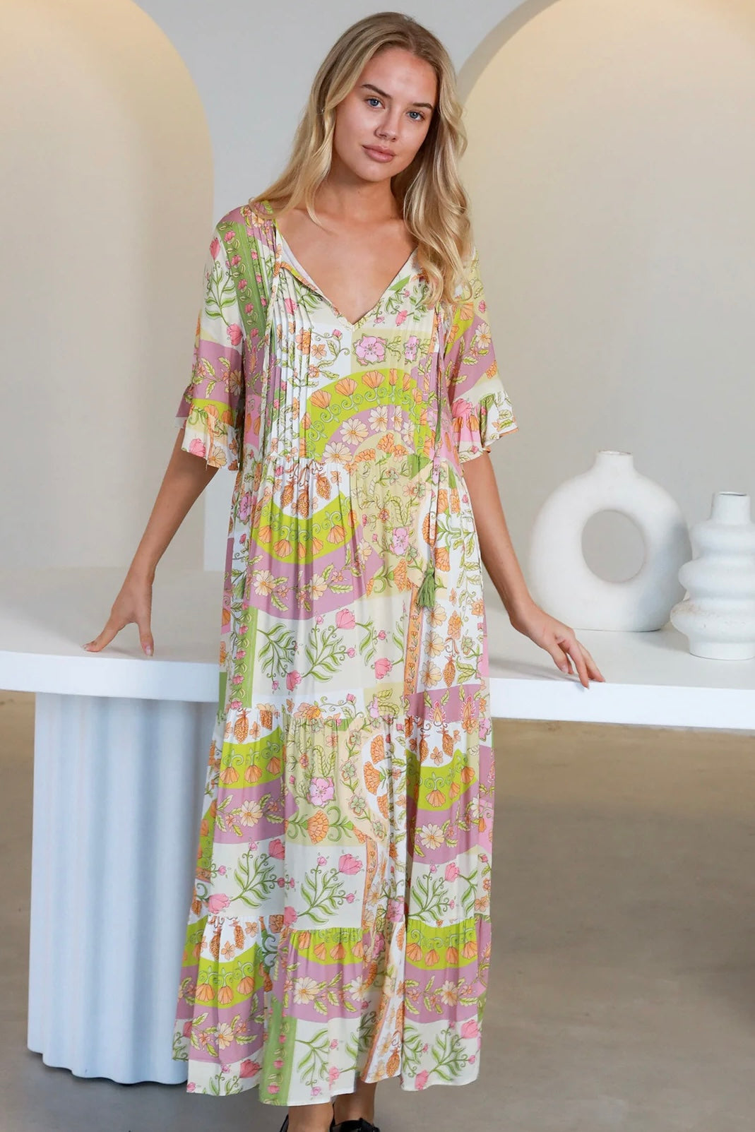 “Woman in vintage floral boho midi-maxi dress with tassel ties, frilled sleeves and tiered skirt – boho midi dresses Australia”