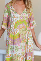 “Woman in vintage floral boho midi-maxi dress with tassel ties, frilled sleeves and tiered skirt – boho midi dresses Australia”