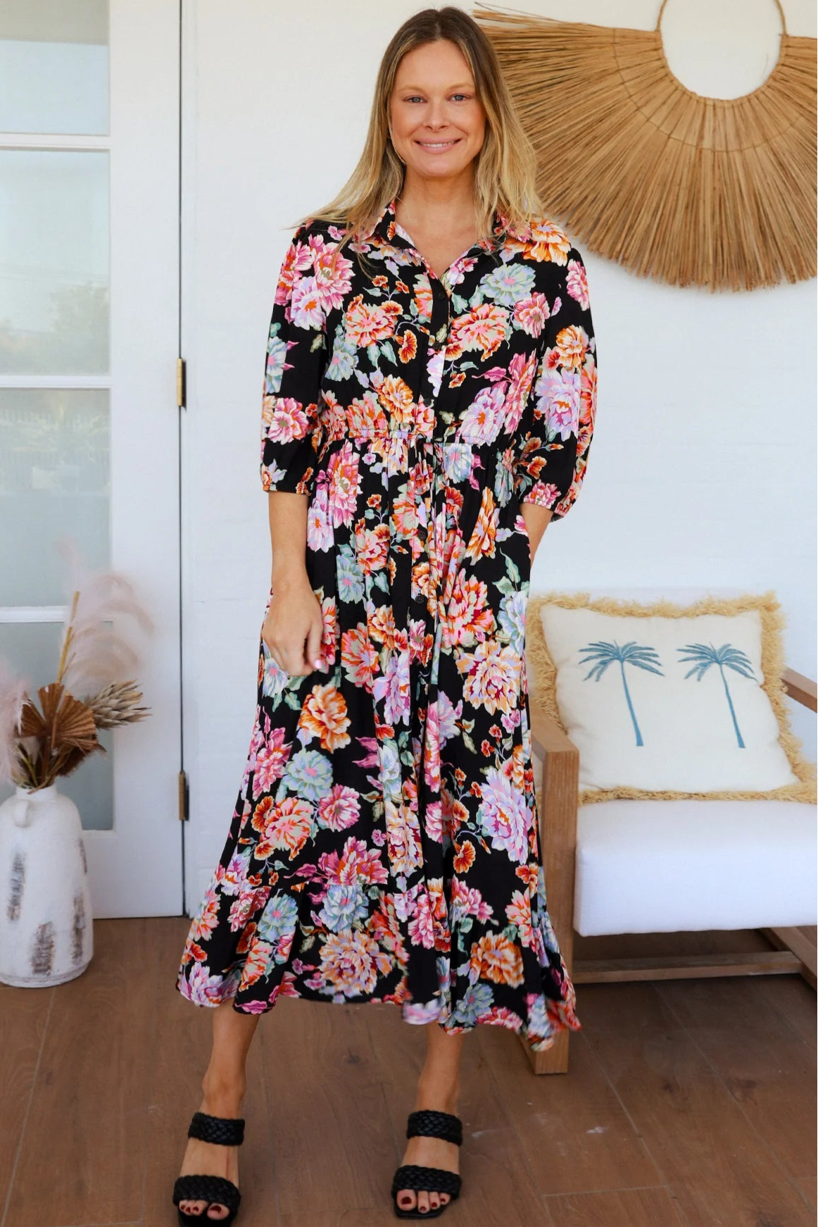 Black floral boho midi dress with painterly blooms, button front, frill hem, drawstring waist, half sleeves and pockets.