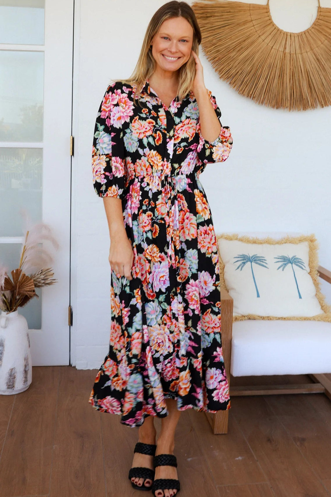 Black floral boho midi dress with painterly blooms, button front, frill hem, drawstring waist, half sleeves and pockets.