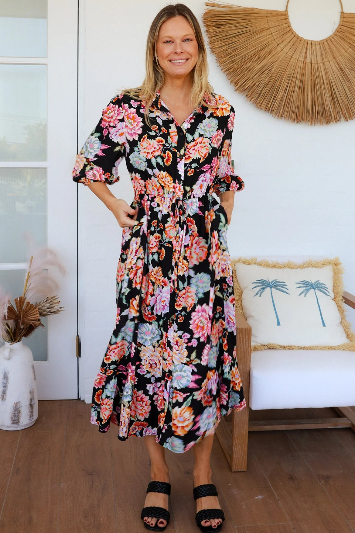 Black floral boho midi dress with painterly blooms, button front, frill hem, drawstring waist, half sleeves and pockets.