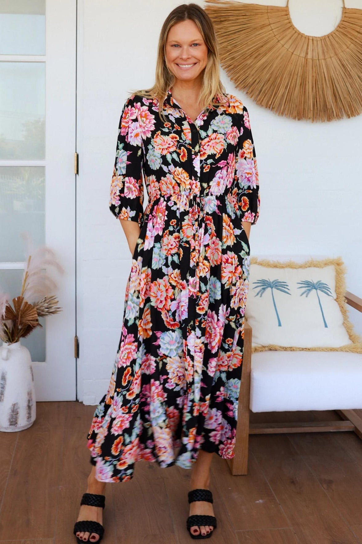 Black floral boho midi dress with painterly blooms, button front, frill hem, drawstring waist, half sleeves and pockets.