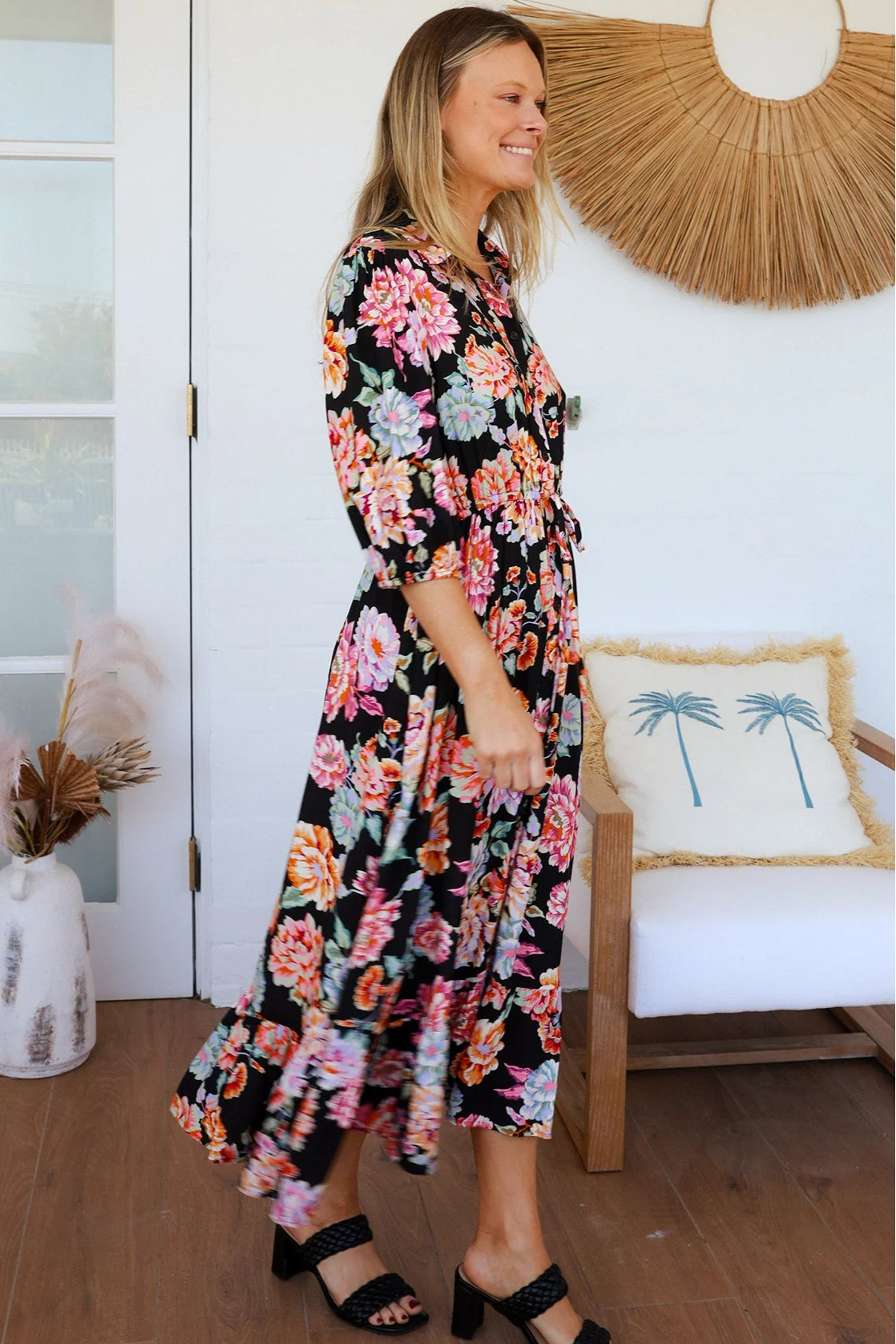 Black floral boho midi dress with painterly blooms, button front, frill hem, drawstring waist, half sleeves and pockets.