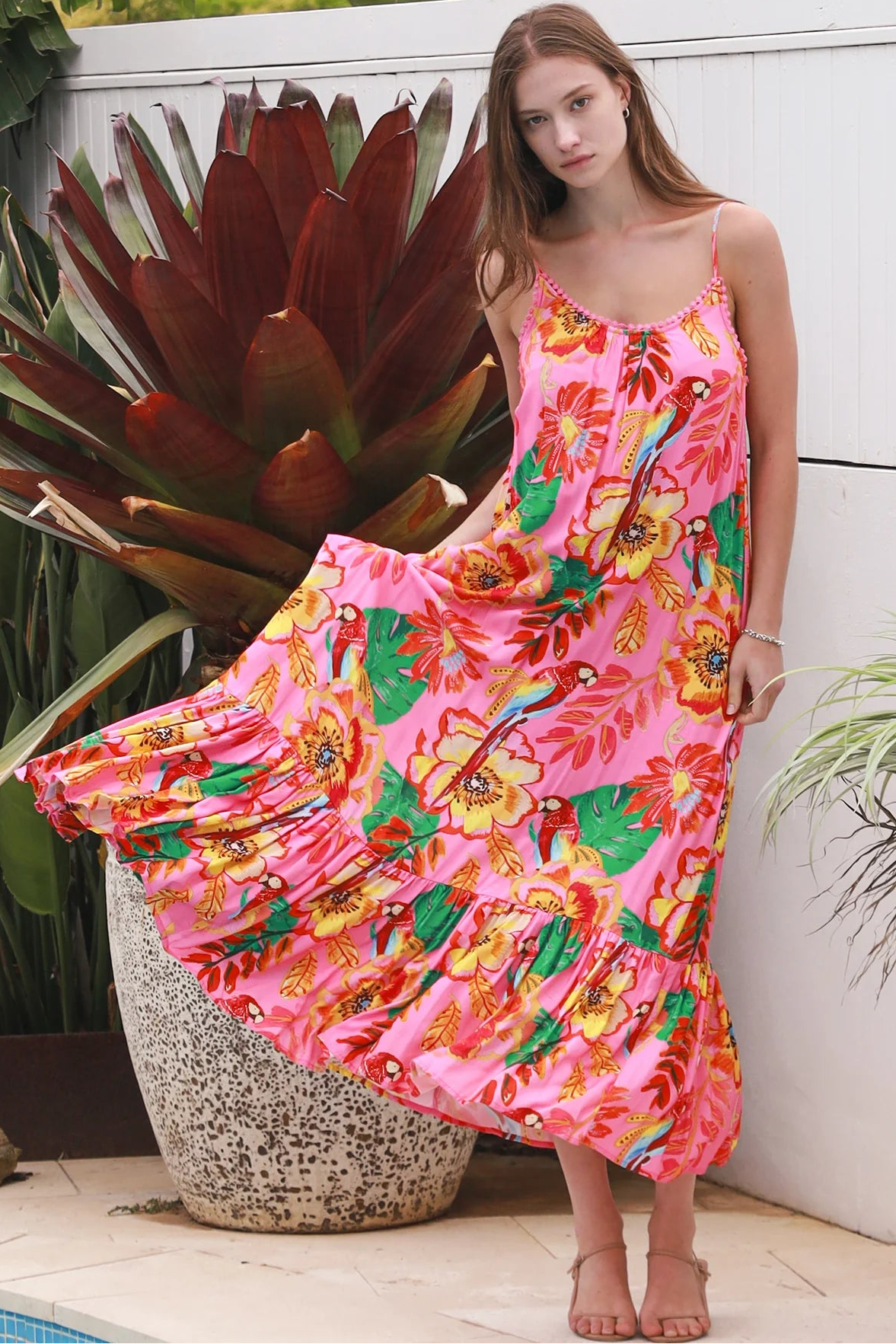 Pink floral slip maxi dress with poppy and parrot print, adjustable shoestring straps and crochet trim neckline