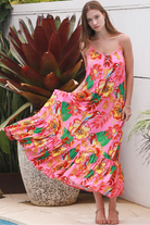 Pink floral slip maxi dress with poppy and parrot print, adjustable shoestring straps and crochet trim neckline