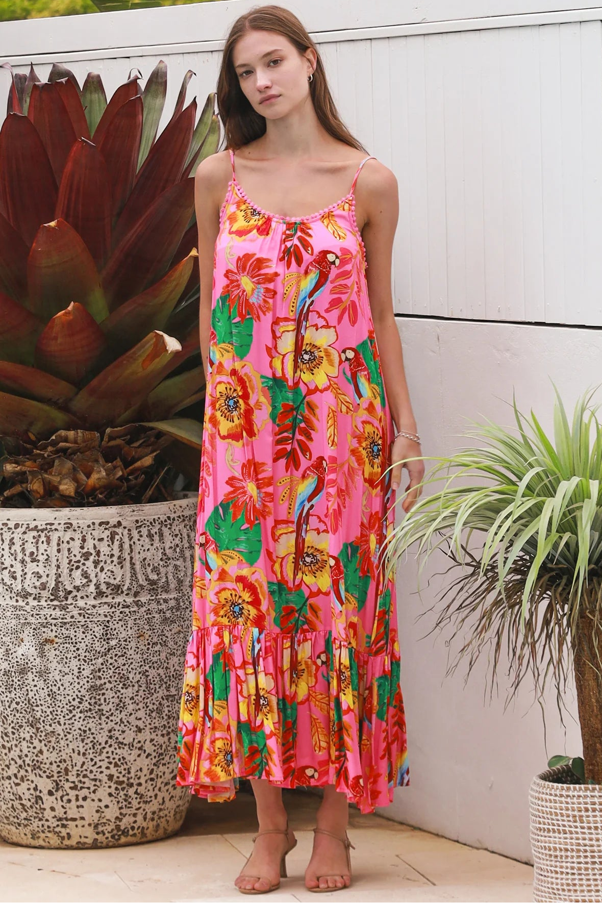 Pink floral slip maxi dress with poppy and parrot print, adjustable shoestring straps and crochet trim neckline