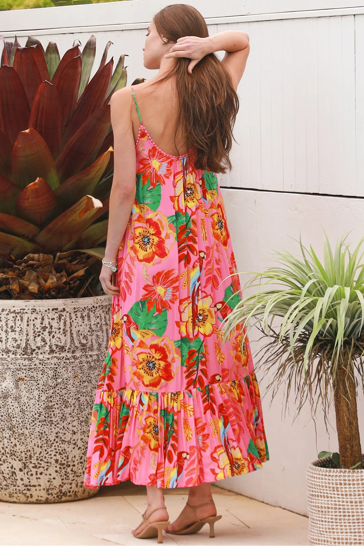 Pink floral slip maxi dress with poppy and parrot print, adjustable shoestring straps and crochet trim neckline