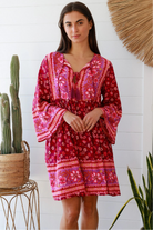 Raspberry floral bohemian mini dress with border print and flared sleeves Australian boho fashion