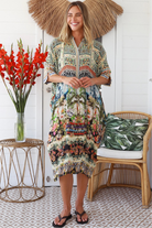 Woman wearing Oasis Kaftan Midi Dress in neutral geometric print with mosaic sleeve trim and petite collar – Peacock Feather Resort Collection