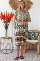 Woman wearing Oasis Kaftan Midi Dress in neutral geometric print with mosaic sleeve trim and petite collar – Peacock Feather Resort Collection