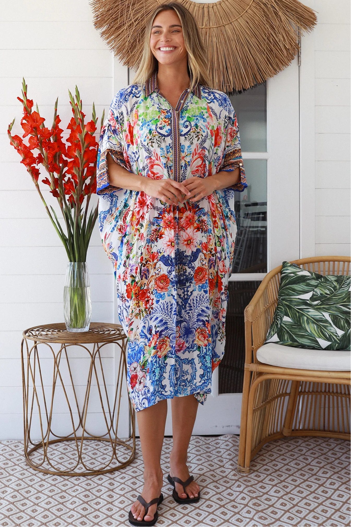 Woman in white viscose crepe kaftan midi dress with coral, jade and cobalt florals by Peacock Feathers Resort Luxe – Boho Dresses Australia