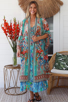 Woman in Lagoon Blue viscose - linen boho midi dress with beaded neckline from the Peacock Feather Resort Luxe Collection - Boho Dresses Australia 