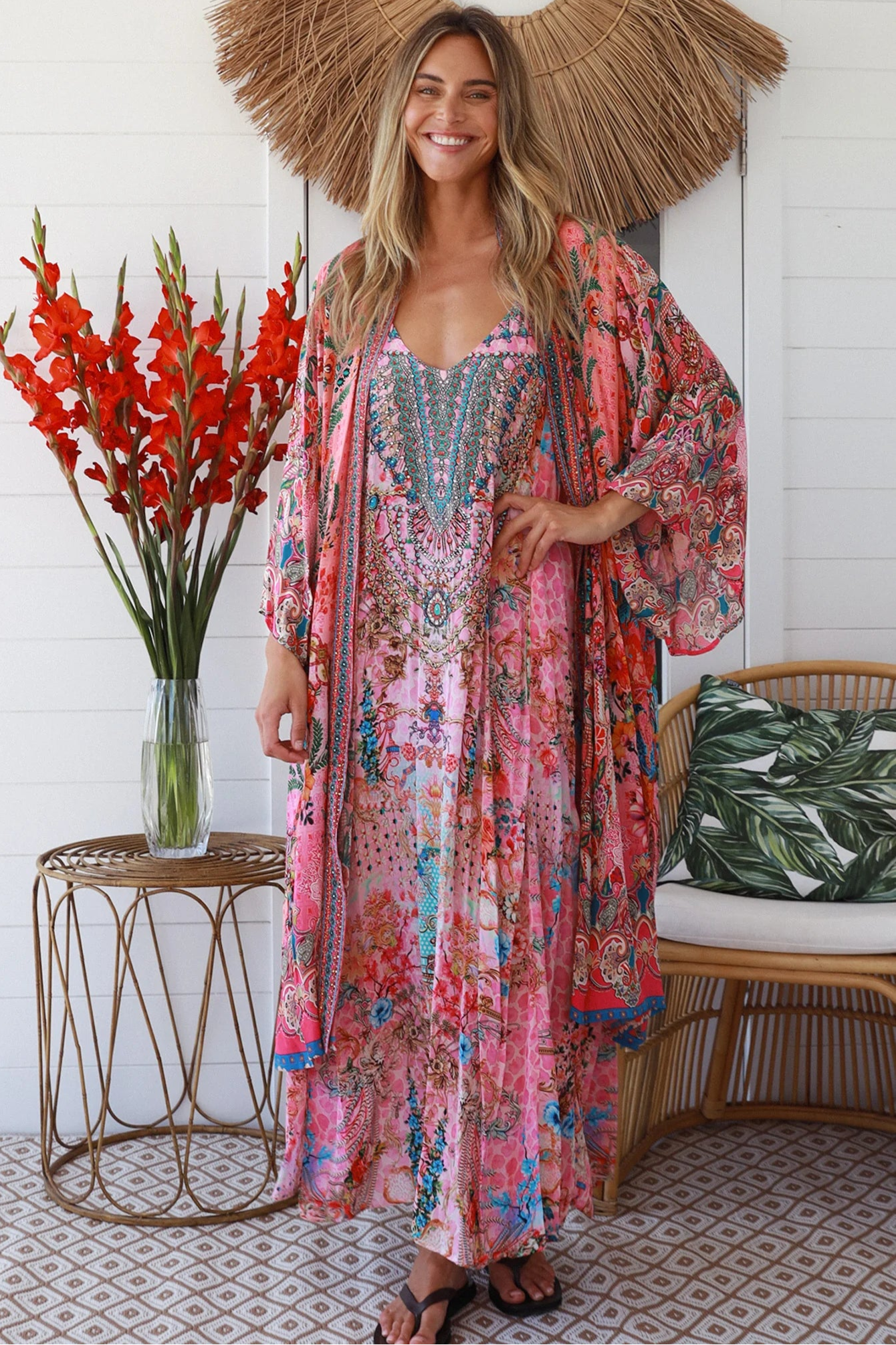 Woman in rose floral linen-viscose kimono with turquoise accents and side splits - Peacock Feather Resort Luxe