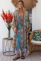 Woman wearing blue floral linen - viscose boho kimono with side splits - Peacock Feather Resort Luxe Australia.
