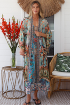 Woman wearing blue floral linen - viscose boho kimono with side splits - Peacock Feather Resort Luxe Australia.