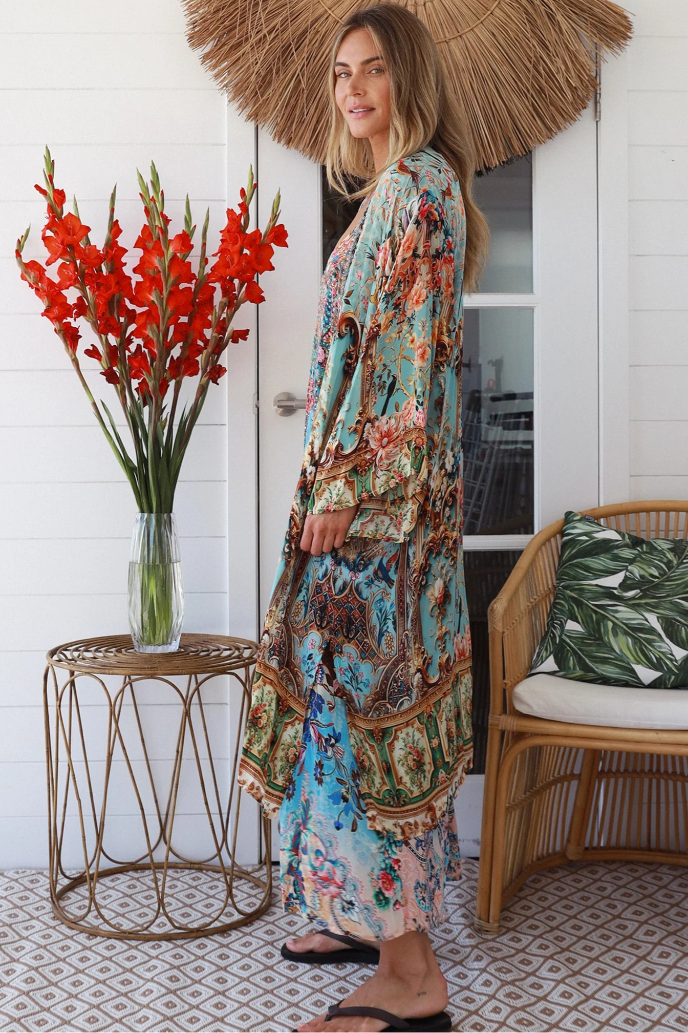 Woman wearing blue floral linen - viscose boho kimono with side splits - Peacock Feather Resort Luxe Australia.