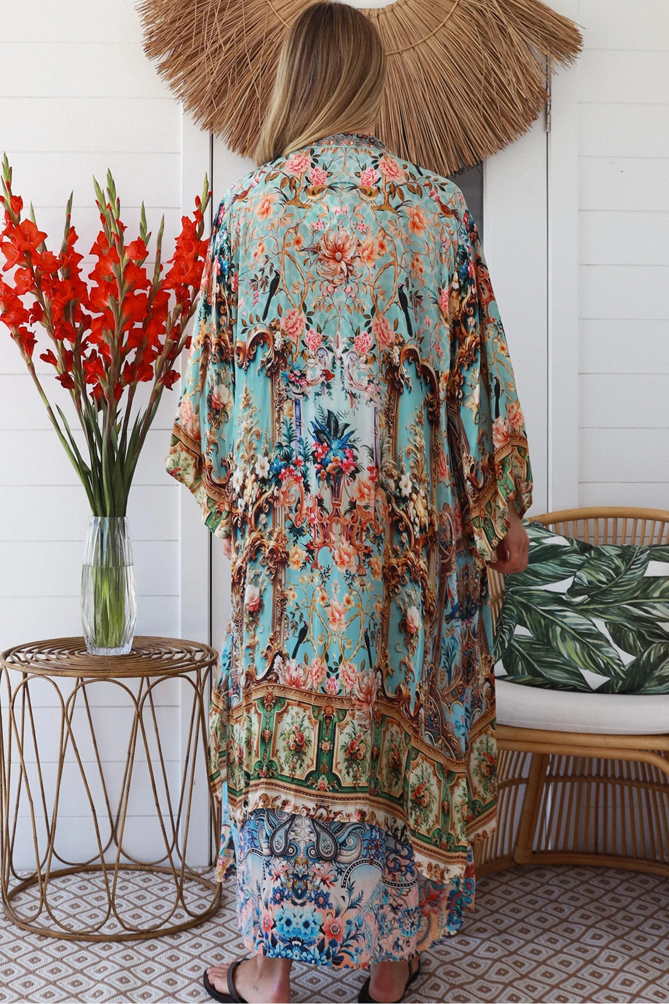 Woman wearing blue floral linen - viscose boho kimono with side splits - Peacock Feather Resort Luxe Australia.
