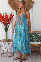 Woman in Lagoon Blue viscose - linen boho midi dress with beaded neckline from the Peacock Feather Resort Luxe Collection - Boho Dresses Australia 