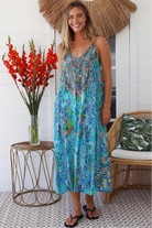 Woman in Lagoon Blue viscose - linen boho midi dress with beaded neckline from the Peacock Feather Resort Luxe Collection - Boho Dresses Australia 