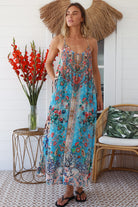 Woman wearing turquoise blue floral resort luxe midi dress with racerback straps - boho resort wear Australia