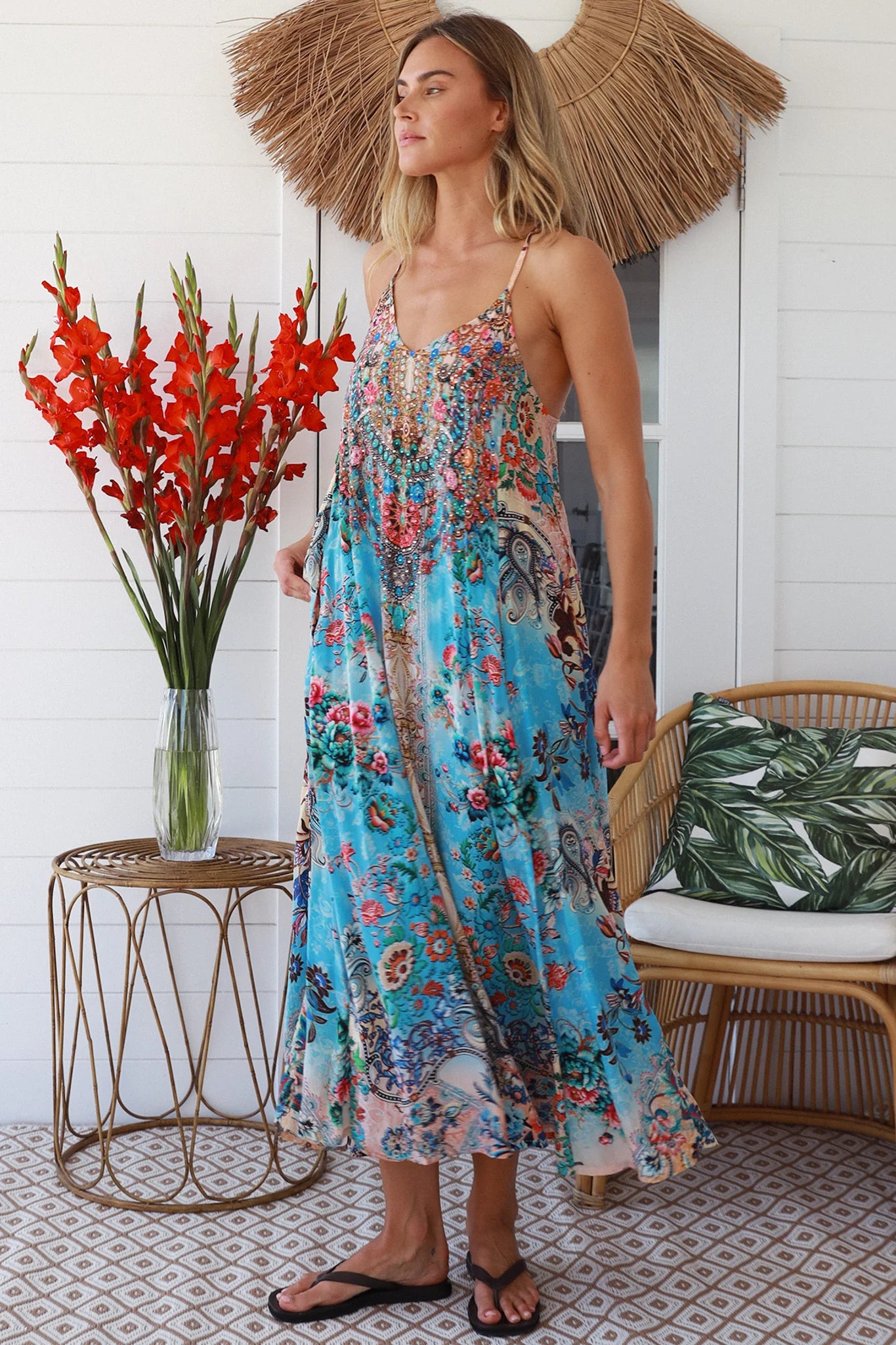 Woman wearing turquoise blue floral resort luxe midi dress with racerback straps - boho resort wear Australia