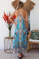 Woman wearing turquoise blue floral resort luxe midi dress with racerback straps - boho resort wear Australia