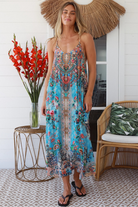 Woman wearing turquoise blue floral resort luxe midi dress with racerback straps - boho resort wear Australia