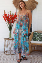 Woman wearing turquoise blue floral resort luxe midi dress with racerback straps - boho resort wear Australia