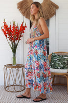 Woman in white boho midi dress with blue and coral floral mosaic print, racer back and adjustable straps - Australian boho fashion