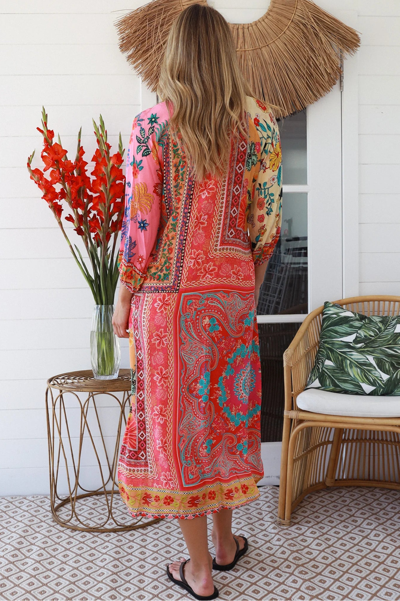 Woman in a colourful viscose-linen boho patchwork midi dress with v-neck collar, button front & 3/4 sleeves.